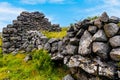 Old Irish celtic buildings stone ruins at coastline