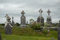 Old Irish graveyard with crosses and wild flowers