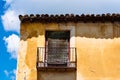 Old Iron Balcony in Aged Yellow Plaster Facade Royalty Free Stock Photo