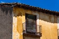 Old Iron Balcony in Aged Yellow Plaster Facade Royalty Free Stock Photo