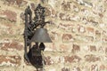 Old iron bell placed on a brick wall Royalty Free Stock Photo