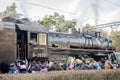 Old iron black retro vintage Soviet steam locomotive with red star arrives at the railway station to board passengers Royalty Free Stock Photo