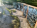 Old iron blue metal rusty peeling railing, fences with peeling cracked paint against the background of the water, the river Royalty Free Stock Photo