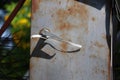 The old iron cabinet is rusty, there is a bolt on the island, the control box is attached to the electrical box outside