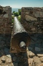 Old iron cannon aiming through crenel in wall at the Marvao Castle Royalty Free Stock Photo