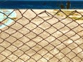 The old iron chain link fence, metal wire net in front of cement floor background in the school, for security barrier safety zone.