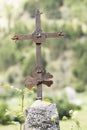 Old iron cross on a simple tombstone Royalty Free Stock Photo