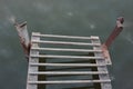 River Landscape of old iron dock looks like a ladder to clouds. Stairway to heaven concept. Royalty Free Stock Photo