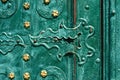 Old iron door, forged and painted in green color with golden flowers for background, vintage style, retro elements Royalty Free Stock Photo