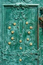 Old iron door, forged and painted in green color with golden flowers for background, vintage style, retro elements Royalty Free Stock Photo