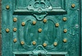 Old iron door, forged and painted in green color with golden flowers for background, vintage style, retro elements Royalty Free Stock Photo