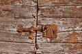 Old iron door latch on wooden door Royalty Free Stock Photo