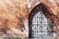 An old iron door in an old brick wall, fortification. Royalty Free Stock Photo