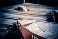 Old iron frayed and shabby boat noses tied to wooden dock and cat Royalty Free Stock Photo