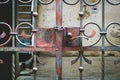 The old iron gate is locked with a metal chain. Close up of a slatted door to an empty courtyard