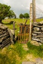 Old iron gate stile in dry stone wall