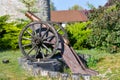 Old iron gun. A cannon that shoots cores. Burning wick. Current model of an old artillery gun. naked gun, cannon on wheels, Royalty Free Stock Photo