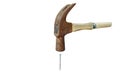 Old iron hammer smashing on nail in white background