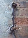 Old iron hooks on broken red brick wall. Caribbean construction Royalty Free Stock Photo