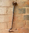 Old iron hooks on broken red brick wall. Caribbean construction Royalty Free Stock Photo