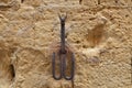 Old iron hooks embedded in a stone wall, used to leave tethered animals like horses or mules. Siena, Italy Royalty Free Stock Photo