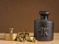 Old iron 1kg weight and smaller brass weights for a kitchen scale Royalty Free Stock Photo