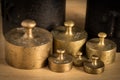 Old iron 1kg weight and smaller brass weights for a kitchen scale Royalty Free Stock Photo