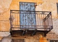 Old Iron Lace Balcony on Faded Stucco House, Greece Royalty Free Stock Photo