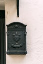 Old iron mailbox on a white facade Royalty Free Stock Photo