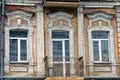 Old iron open balcony on a brick wall with windows and a glass door Royalty Free Stock Photo