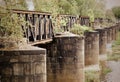 Old iron railroad bridge with round supporting pillars in the river Elbe in Magdeburg, Germany Royalty Free Stock Photo