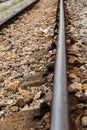 Old iron railroad track laid close up on a gravel background