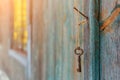 An old iron retro key hanging on a nail against the wall of a rustic wooden house, the concept of a secret, inheritance, Royalty Free Stock Photo