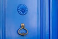 Old iron ring on vintage blue retro door for knocking on facade classic house Royalty Free Stock Photo