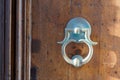 Old iron ring on wooden classic door for knocking on facade house Royalty Free Stock Photo