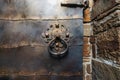 Old iron rusty antique door and door handle or knocker Royalty Free Stock Photo