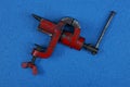 iron tool clamp vise lies on a blue table Royalty Free Stock Photo