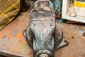 Old iron vise on a shelf in a tool garage