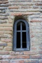 Old iron window in the church wall Royalty Free Stock Photo