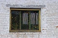 Old Iron Window With A Lattice On A Gray Brick Wall