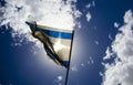 Old Israeli flag on blue sky and white clouds