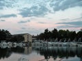 The old Istrian stone house, on a steady stream of water, with many boats in the port in the dark with a magnificent reflection on Royalty Free Stock Photo