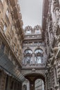 An old Italian house with a narrow yard. Typical Mediterranean building with carved facades. History and architecture. Vertical