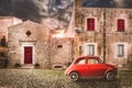 Old Italian House With Small Subcompact Old Red Car Parked Outside, Fiat 500. Vintage Scene