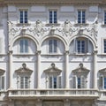Old italian neoclassical building with plastered wall, floral style stucco decorations and elegant windows