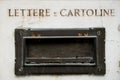 Old italian postbox on ancient marble wall of house in metal, symbol of vintage correspondence and mail