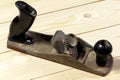 Old jack plane, hand plane on a wooden background, top view. Carpenter`s tools Royalty Free Stock Photo