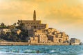 Old Jaffa city, old port and coastal line of Tel Aviv under sunset and lots of tourists are swimming and surfing at the