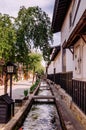 Old Japanese houses on street and small natural stream of Hida F