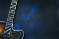 Old, jazz electric guitar on a blue grunge background. Copy space. Background for music festivals, concerts. Musical education. Royalty Free Stock Photo